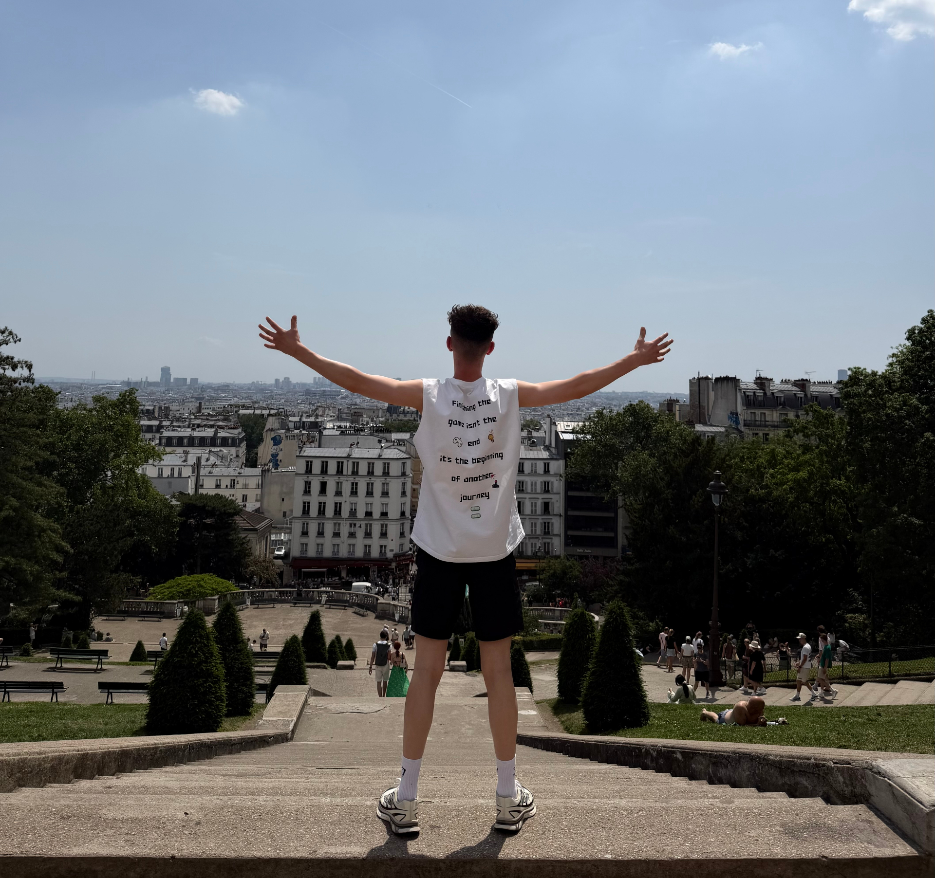Overlooking Paris from Montmartre — arms open to the horizon